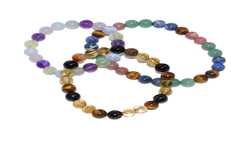 Set of multicolored beaded bracelets on a white background