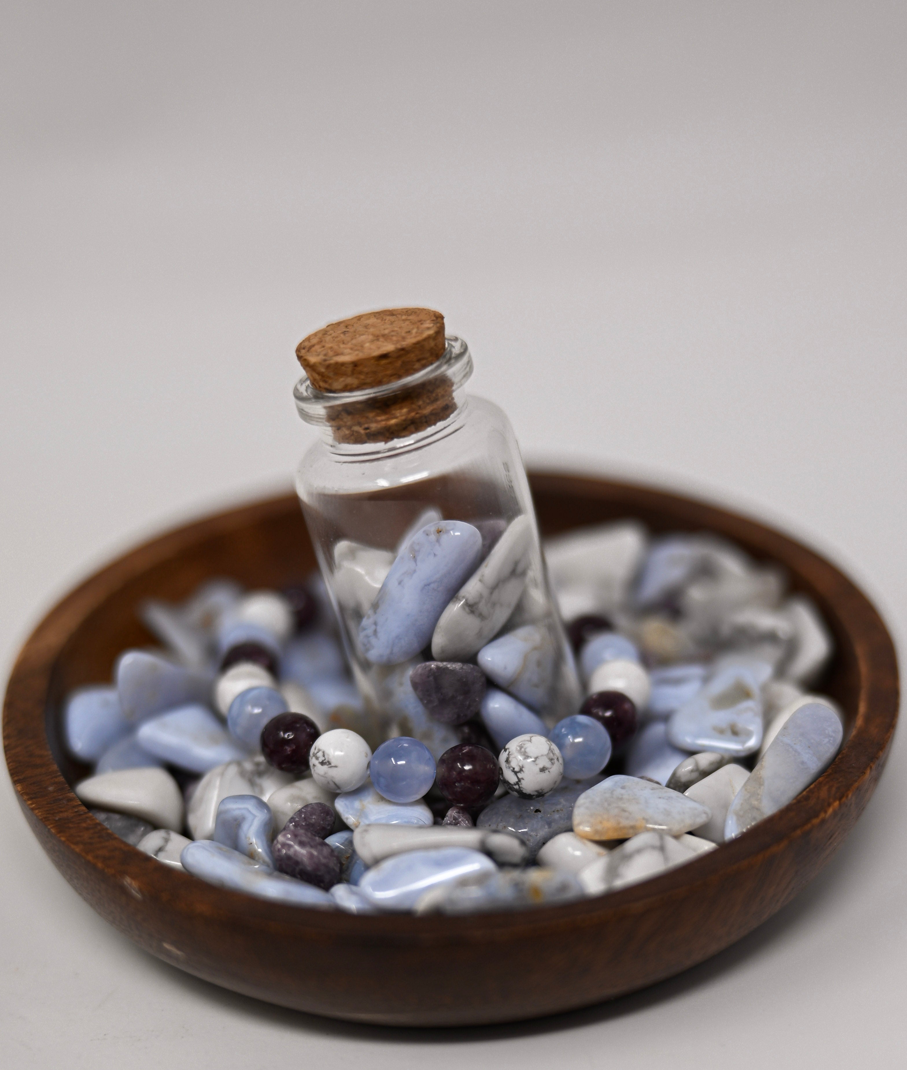 Pale-blue and purple stones in a corked vial