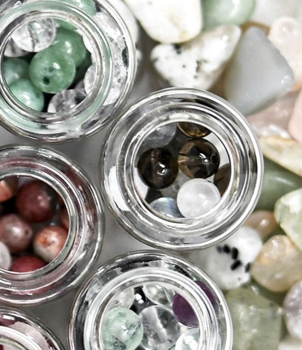 Looking into bottles of colorful crystal stones